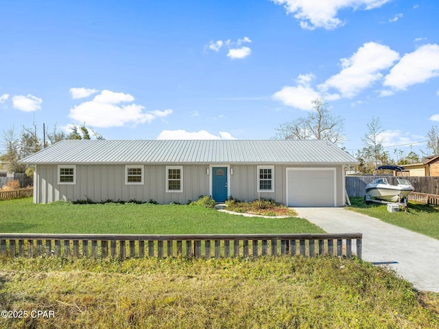 view of front of home featuring a garage and a front lawn