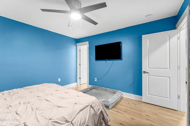 bedroom featuring light wood-type flooring and ceiling fan