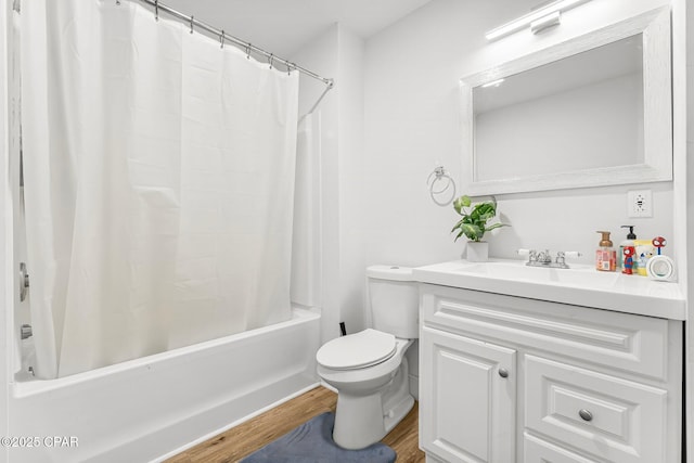 full bathroom with vanity, wood-type flooring, toilet, and shower / bath combo with shower curtain