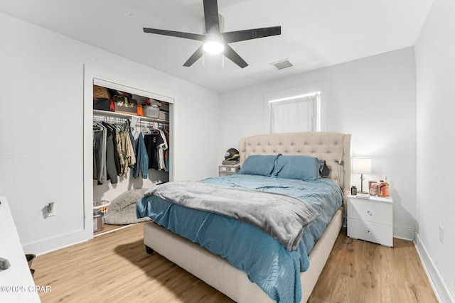 bedroom with hardwood / wood-style flooring, a closet, and ceiling fan