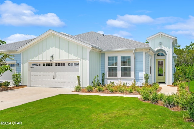 view of front of home featuring a garage and a front yard