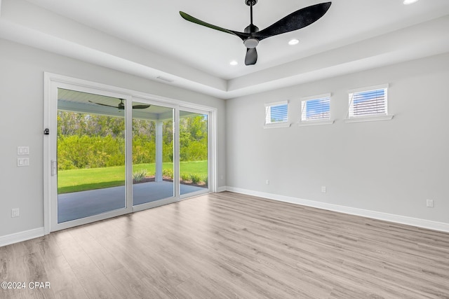 spare room featuring light hardwood / wood-style flooring and ceiling fan