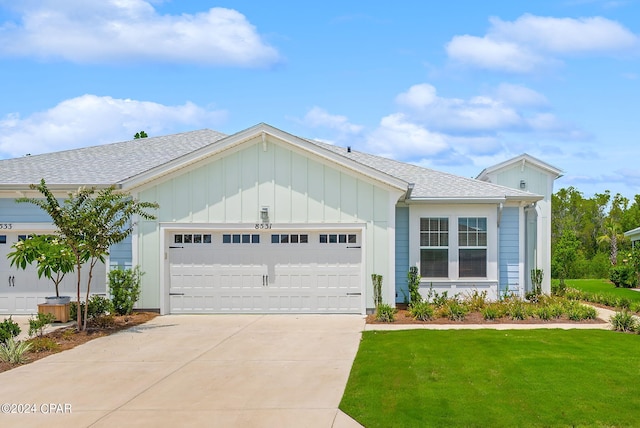 view of front of home featuring a garage and a front yard