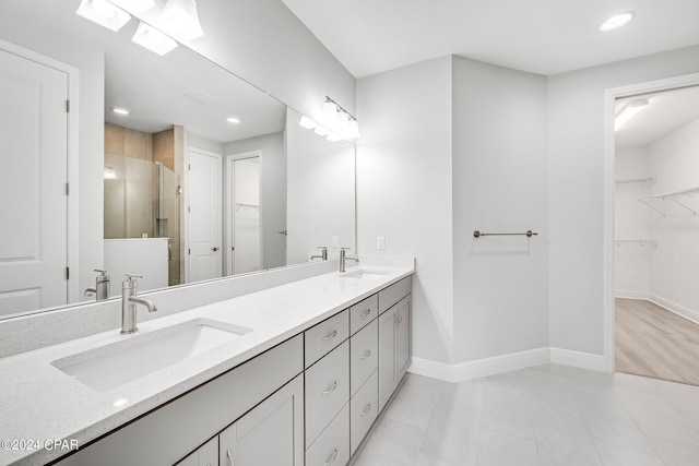 bathroom featuring tile patterned floors, vanity, and an enclosed shower