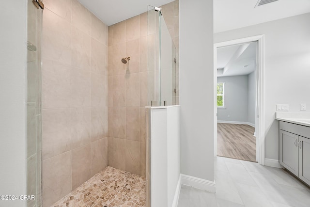 bathroom featuring vanity and tiled shower