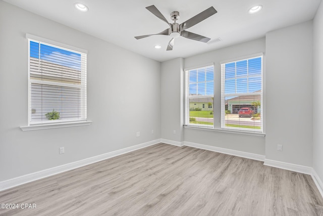 unfurnished room featuring ceiling fan, a healthy amount of sunlight, and light wood-type flooring