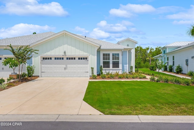 view of front of house with a front yard and a garage