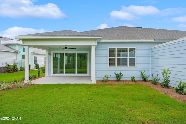 rear view of property with central air condition unit, a patio area, ceiling fan, and a yard