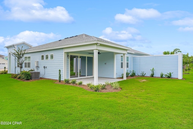 rear view of property with a lawn, ceiling fan, and a patio