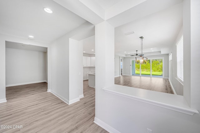 kitchen with light hardwood / wood-style flooring and a chandelier