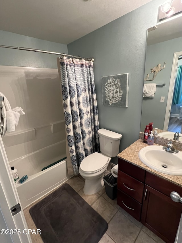 full bathroom featuring tile patterned floors, vanity, shower / bath combo, and toilet