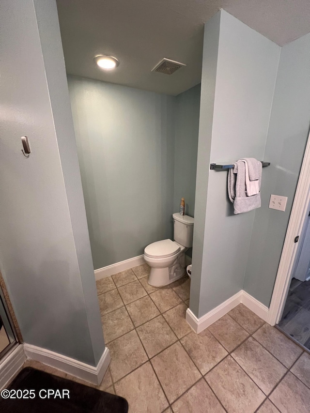 bathroom featuring tile patterned flooring and toilet