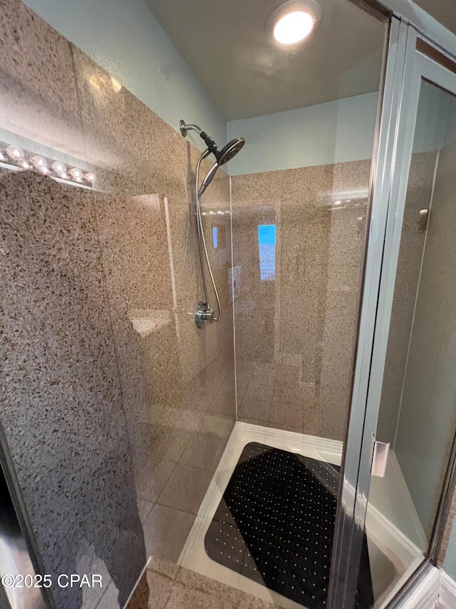 bathroom with a tile shower