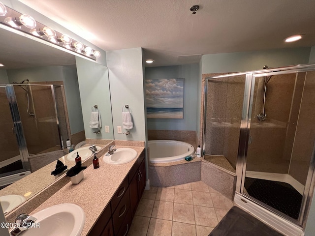 bathroom with tile patterned flooring, vanity, and shower with separate bathtub