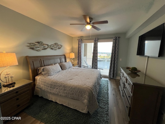 bedroom with access to exterior, ceiling fan, and dark wood-type flooring