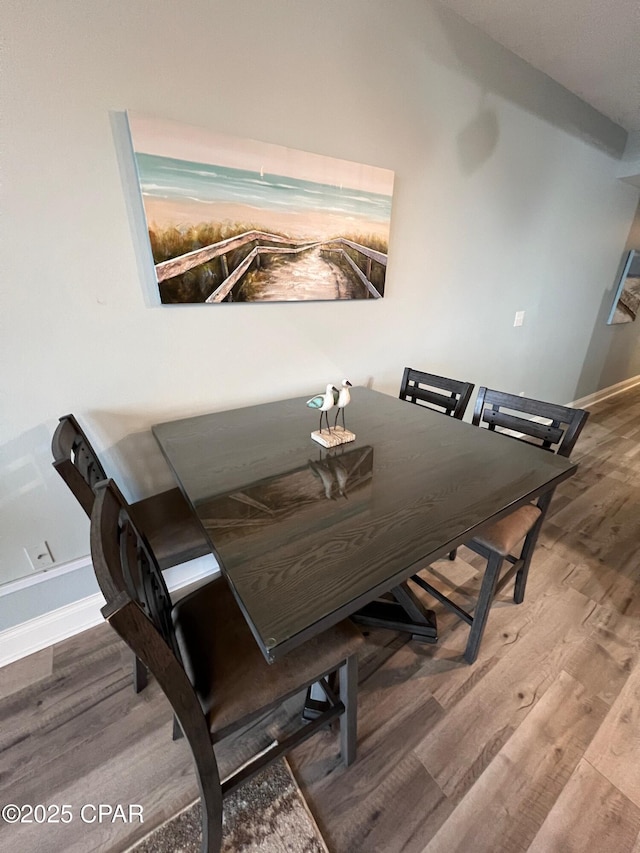 dining area with hardwood / wood-style floors