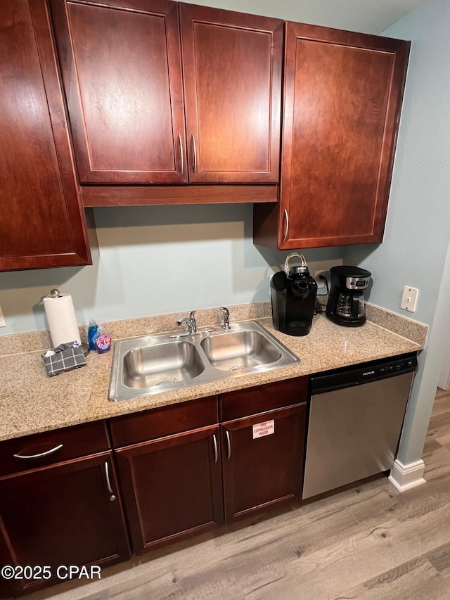 kitchen featuring dishwasher, light hardwood / wood-style flooring, and sink