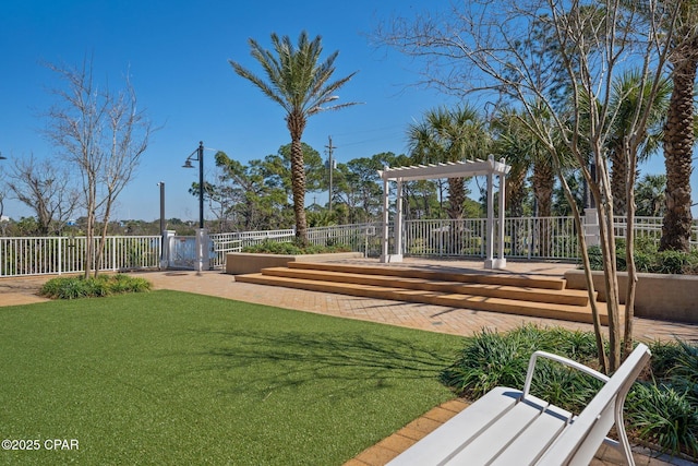 view of property's community with a pergola and a lawn