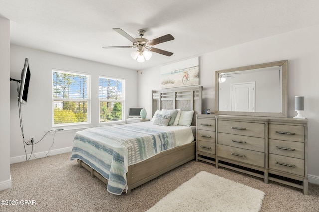 bedroom featuring light carpet and ceiling fan