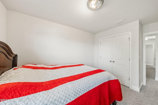 bedroom with light colored carpet and a closet