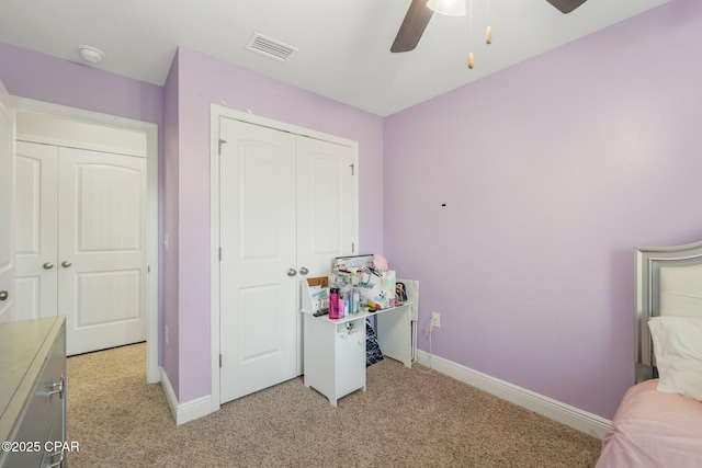 carpeted bedroom featuring ceiling fan and a closet