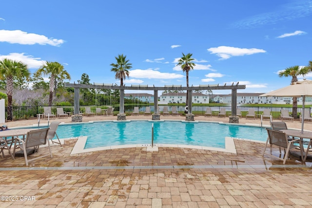 view of swimming pool with a patio and a pergola