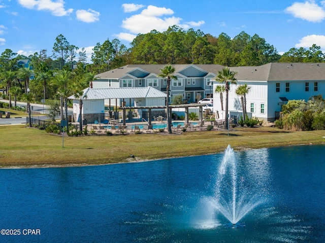 exterior space with a water view and a lawn