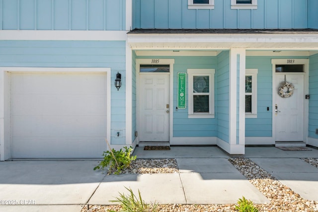 entrance to property with a porch and a garage