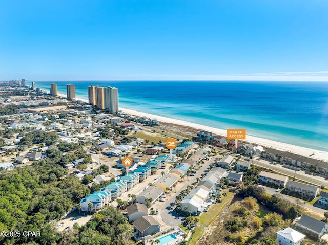 drone / aerial view featuring a water view and a beach view