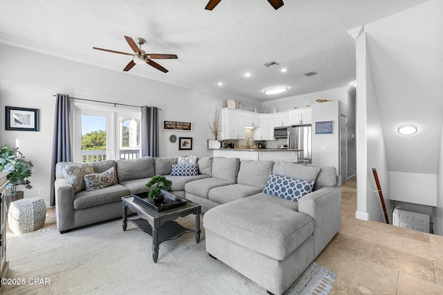 living area with stone tile flooring, visible vents, crown molding, and ceiling fan