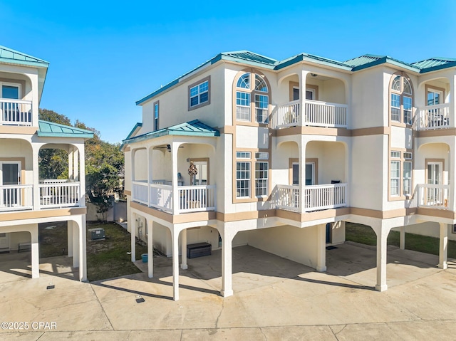 17878 Front Beach Rd Unit E2, Panama City Beach, FL 32413 - view of front of house with a standing seam roof, metal roof, and stucco siding