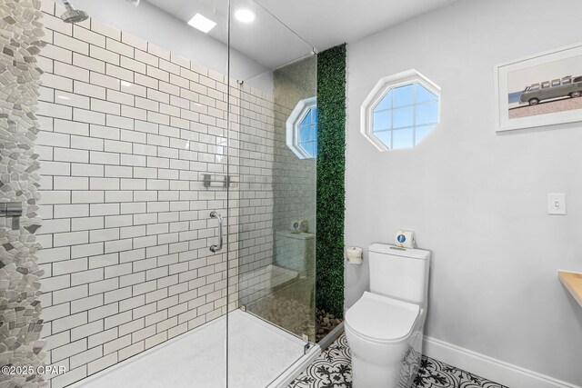 bathroom featuring toilet, tile patterned floors, and a shower with shower door