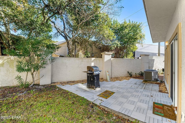 view of yard with cooling unit, a fenced backyard, and a patio