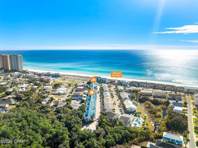 birds eye view of property featuring a water view and a beach view