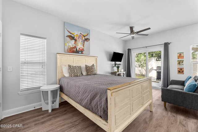 bedroom featuring dark hardwood / wood-style flooring, access to outside, and ceiling fan