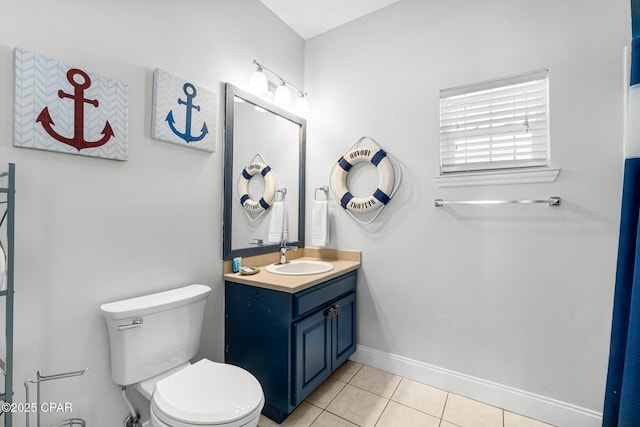 bathroom featuring toilet, vanity, and tile patterned floors