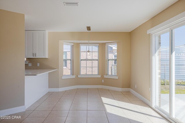 unfurnished living room with a fireplace, light tile patterned floors, ceiling fan, and lofted ceiling