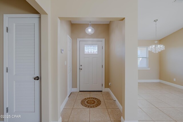 kitchen featuring hanging light fixtures, white cabinets, lofted ceiling, light tile patterned flooring, and appliances with stainless steel finishes