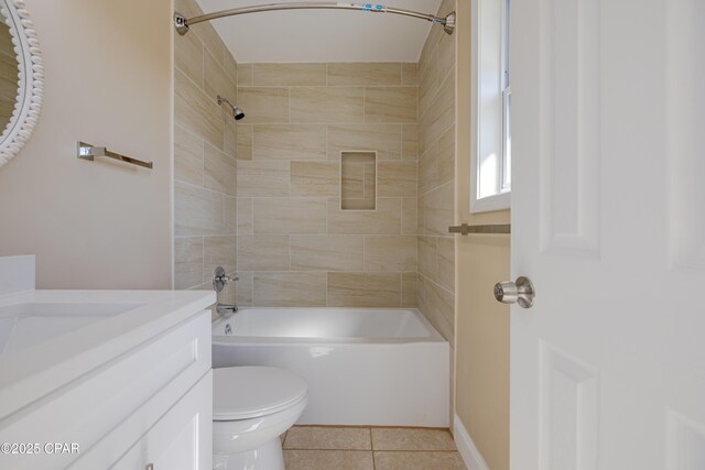 full bathroom featuring tile patterned flooring, vanity, toilet, and tiled shower / bath