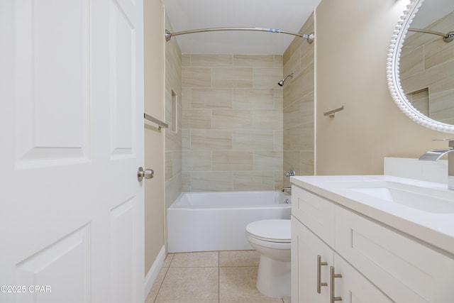 full bathroom featuring tiled shower / bath, tile patterned floors, toilet, and vanity