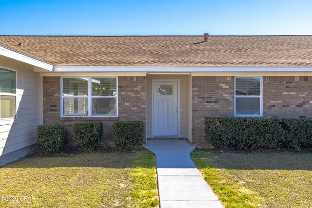 rear view of property with a yard, a patio, and central AC unit