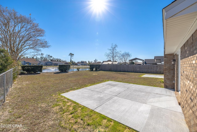 view of yard with a patio and a water view