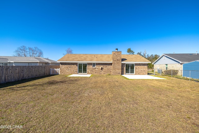 rear view of house with central AC, a lawn, and a patio