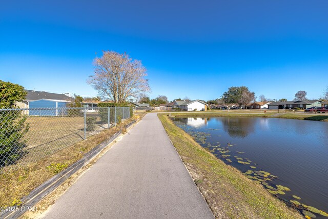 dock area with a yard and a water view