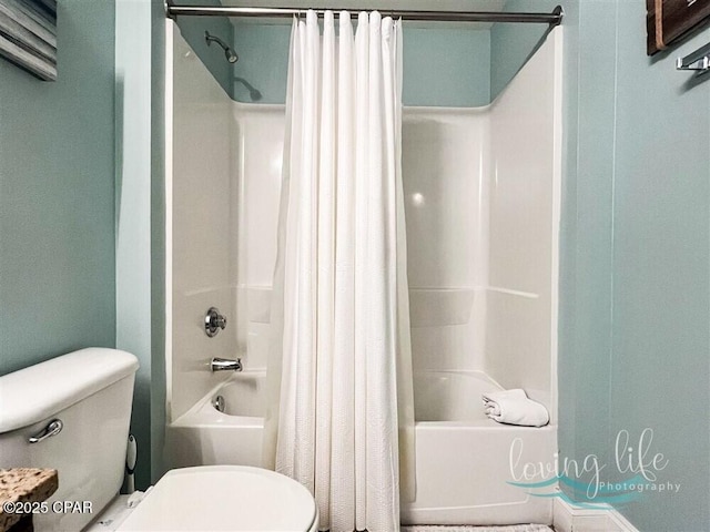 bathroom with shower / bath combination with curtain and toilet