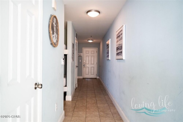 hall with light tile patterned floors