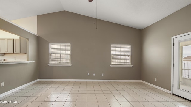 tiled spare room featuring vaulted ceiling and ceiling fan