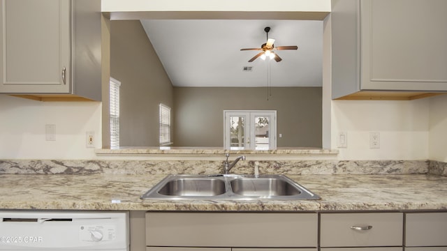 kitchen featuring white dishwasher, sink, and ceiling fan