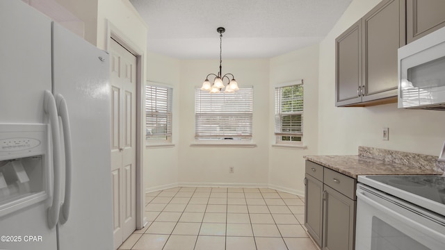 kitchen with a notable chandelier, pendant lighting, white appliances, gray cabinetry, and light tile patterned floors