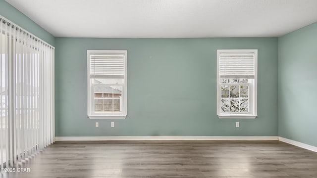 spare room featuring a textured ceiling and wood-type flooring